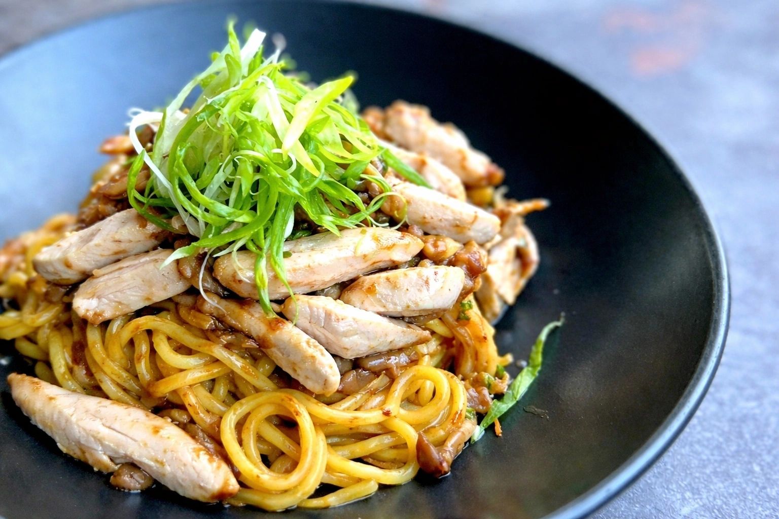Garlic noodles with grilled chicken and greens.
